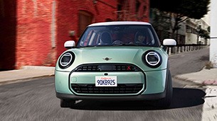 MINI Cooper on road front view MINI Cooper on road front view